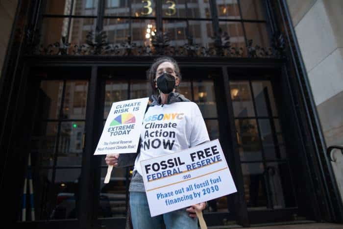 Climate activist outside of the Federal Reserve in NYC